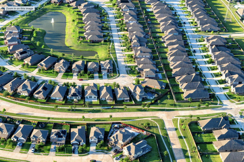 Shows houses in a development by a lake